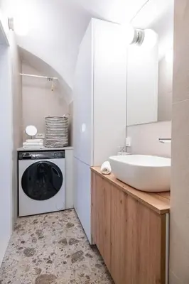 a bathroom with a sink and a washing machine at Trubarjeva City apartments in Ljubljana