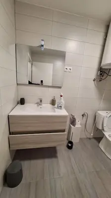 a bathroom with a sink and a mirror at Wellness house ZoJa with outdoor sauna and hot tub in Boštanj