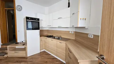 a small kitchen with white cabinets and a sink at Puci Apartment in Šmarje-Sap