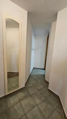 an empty room with a door and a tile floor at Puci Apartment in Šmarje-Sap