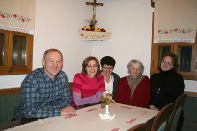 a group of people sitting at a table at Tourist Farm Ob izviru Krupe in Semič