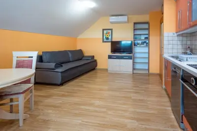 a living room with a couch and a kitchen at Apartment Anja in Zreče