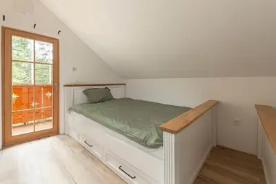 a bedroom with a bed and a window at Luxury Villa TINKA in Zgornje Gorje