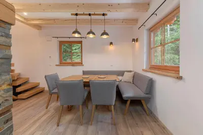 a dining room with a table and chairs at Luxury Villa TINKA in Zgornje Gorje