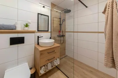 a bathroom with a sink and a shower at Luxury Villa TINKA in Zgornje Gorje