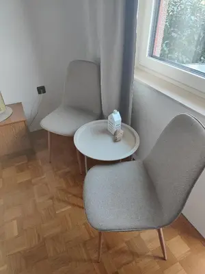 a room with two chairs and a table and a window at Studio za 2 Marko Rogaška Slatina in Rogaška Slatina