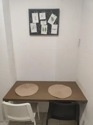 a table in a room with two chairs and signs on the wall at Studio za 2 Marko Rogaška Slatina in Rogaška Slatina