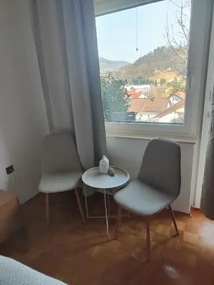 two chairs and a table in a room with a window at Studio za 2 Marko Rogaška Slatina in Rogaška Slatina