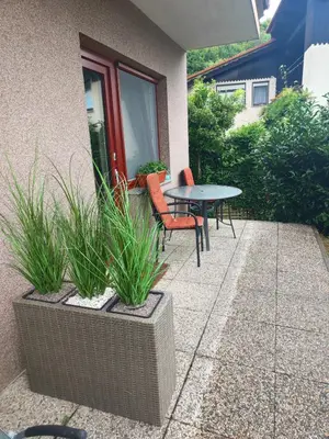 a patio with a table and chairs and plants at Studio za 2 Marko Rogaška Slatina in Rogaška Slatina