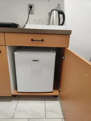 a white dishwasher under a sink in a kitchen at Studio za 2 Marko Rogaška Slatina in Rogaška Slatina