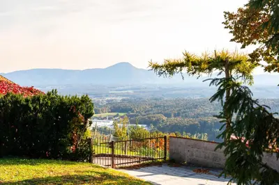 a view of a valley from a hill with a fence at Forest View Apartment - Sauna & Nature Escape in Slovenska Bistrica