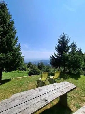 two chairs sitting on top of a wooden bench at apartma Pohorc - Macesen in Pohorje