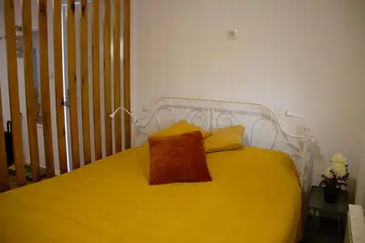 a yellow bed with a yellow pillow on it at Poppqi's home in Polzela