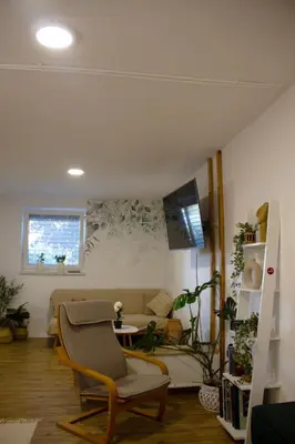 a living room with a couch and a table at Poppqi's home in Polzela