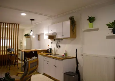 a kitchen with white cabinets and a counter top at Poppqi's home in Polzela