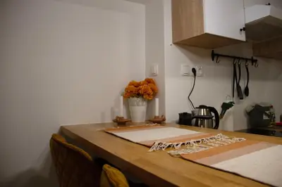 a kitchen table with a vase of flowers on it at Poppqi's home in Polzela