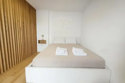 a bedroom with a bed with two towels on it at Erika's home - apartment house in Šenčur