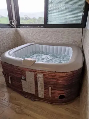 a bath tub in the corner of a bathroom at Cottage in Stara Gora 45720 in Debenec