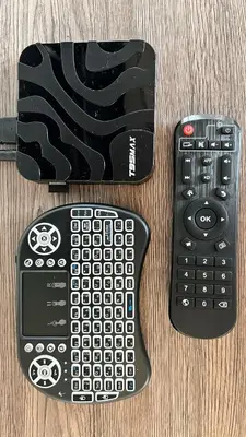 two remote controls sitting on top of a table at Riverbank - Mountain view in Radomlje