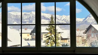 a window with a view of snow covered mountains at Riverbank - Mountain view in Radomlje