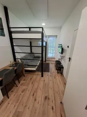 a room with a bunk bed and a table and a desk at apartma Pohorc - Praprot in Pohorje