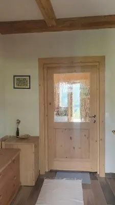 a wooden door with a window in a room at Lojzov toplar Modern haystack in Velike Lašče