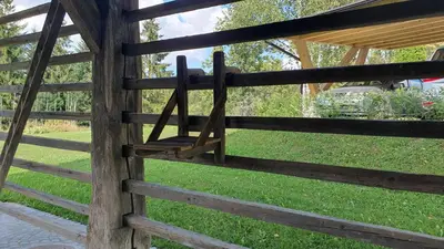 a wooden fence with a gate in a yard at Lojzov toplar Modern haystack in Velike Lašče