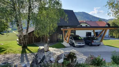 a house with a car parked in front of it at Lojzov toplar Modern haystack in Velike Lašče