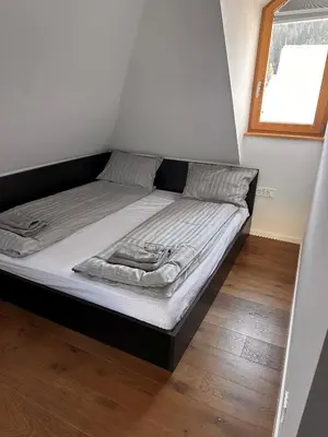 a bed in a small room with a window at Nordic Sun 1 in Kranjska Gora