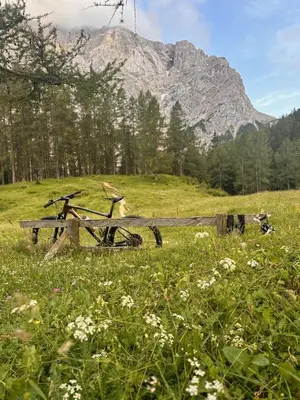 a bike sitting next to a bench in a field at Nordic Sun 1 in Kranjska Gora