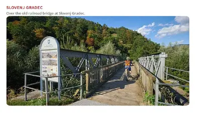 a person riding a bike on a bridge at Apartments Marja in Slovenj Gradec