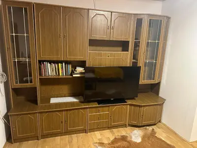 a large wooden entertainment center with a flat screen tv at Apartments Marja in Slovenj Gradec