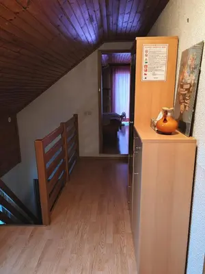 a hallway with a staircase and a room with a pumpkin at Apartment Katja in Križe