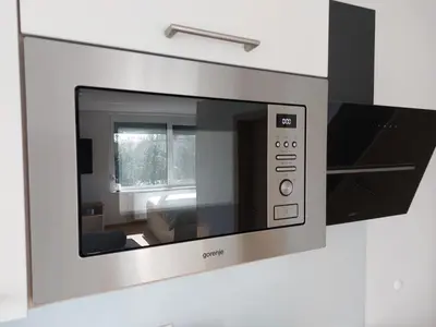 a microwave oven mounted to a wall in a kitchen at 3 JABLANE apartmaji in Beltinci