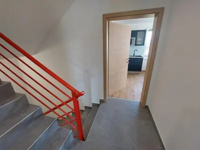 a staircase with a door leading to a bathroom at 3 JABLANE apartmaji in Beltinci