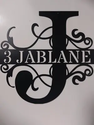 a black sign that says jaberamine on a wall at 3 JABLANE apartmaji in Beltinci