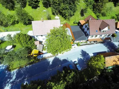 an overhead view of a house with a car in front at Uaštarie u Luogu in Cerkno