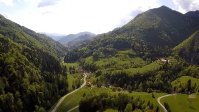 an aerial view of a valley in the mountains at Uaštarie u Luogu in Cerkno
