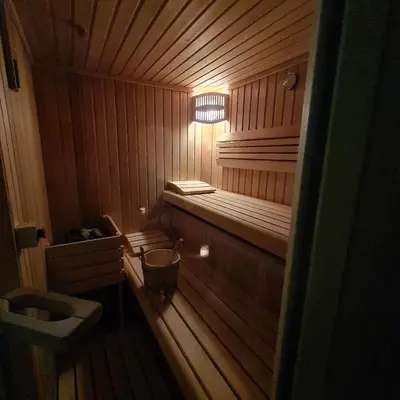 a small wooden sauna with a bench in it at Rosa Bed and Breakfast in Podgorje