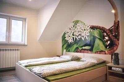 a bed in a room with a painting on the wall at Rosa Bed and Breakfast in Podgorje