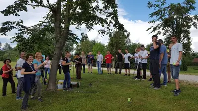 a group of people standing around a tree at Rosa Bed and Breakfast in Podgorje