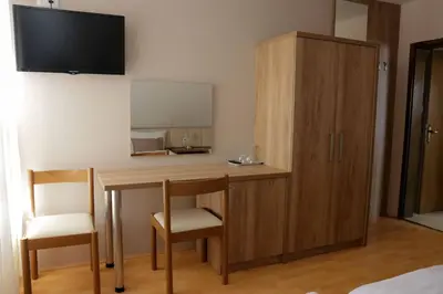 a room with a desk with two chairs and a mirror at Homestay Sreš in Mlaka pri Kranju