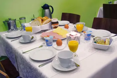 a table with plates of food and drinks on it at Homestay Sreš in Mlaka pri Kranju
