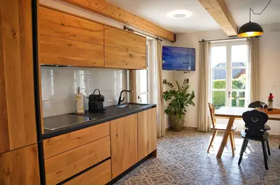 a kitchen with a sink and a table in a room at House Tinka Bled in Bled