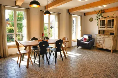a dining room with a table and chairs at House Tinka Bled in Bled