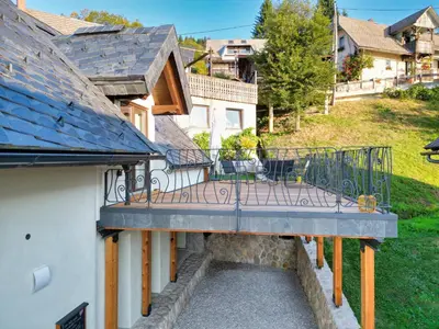 an external view of a house with a balcony at House Tinka Bled in Bled
