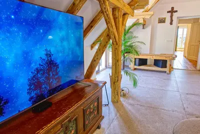a large flat screen tv sitting on top of a table at House Tinka Bled in Bled