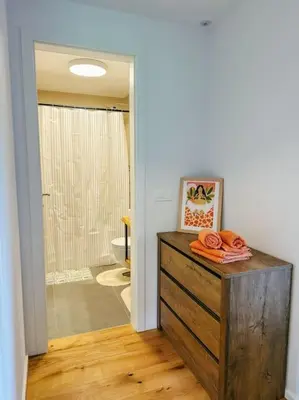 a bathroom with a wooden dresser and a shower at Apartment Kovacic - Lake Bled in Bled