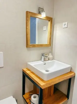 a bathroom with a white sink and a mirror at Apartment Kovacic - Lake Bled in Bled