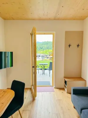 a living room with a door open to a patio at Apartment Kovacic - Lake Bled in Bled